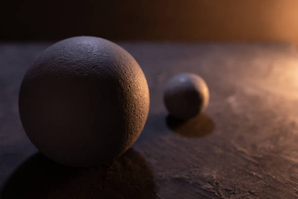 Cement sphere against concrete wall at floor. Abstract geometric or space concept idea