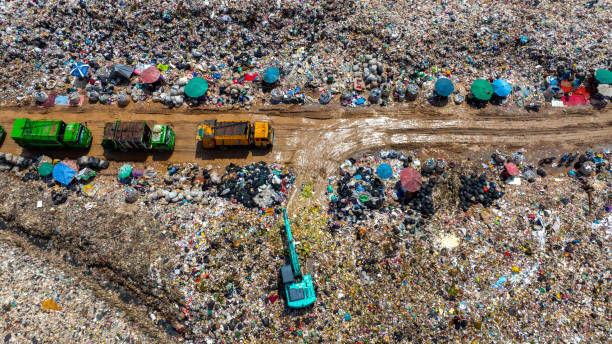 istock Garbage trucks unload garbage over the landfill. Pollution concept. 1426963873