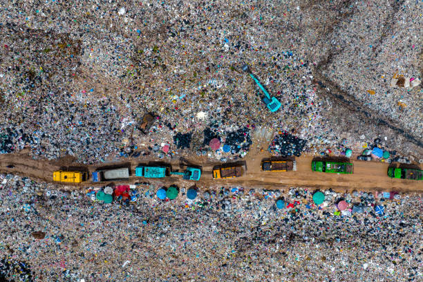 istock Garbage trucks unload garbage over the landfill. Pollution concept. 1426963880