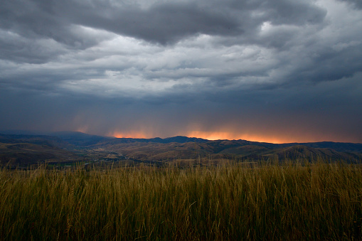 A storm starts to build up as the sun sets over Inkom Idaho on a late summer evening in August of 2022.