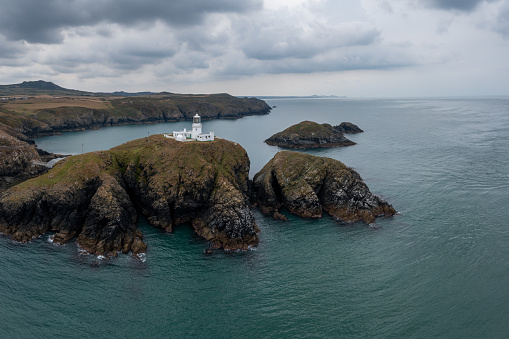 aerial landscape view of the Pembrokeshire coast with the historic Strumble Head Lighthouse