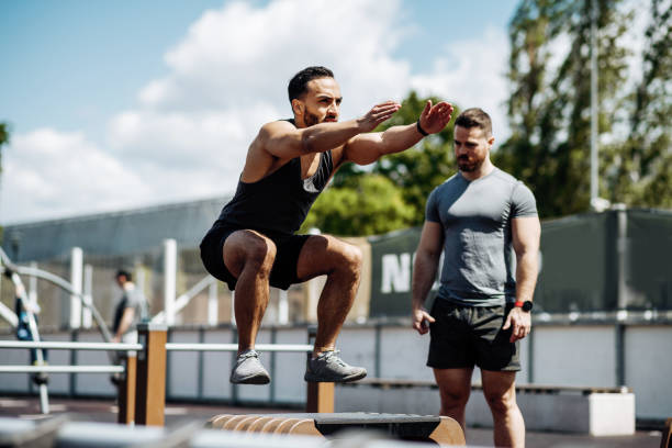 istock Fitness instructor and Latin trainee on outdoor training. Man jumping and doing squats 1426974434