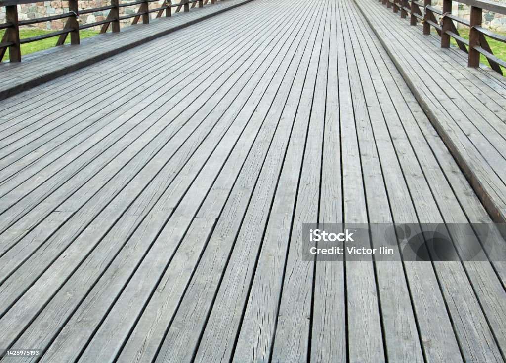wooden bridge made of thick brown boards stylized as retro wooden bridge made of thick brown boards stylized as retro. Ancient Stock Photo