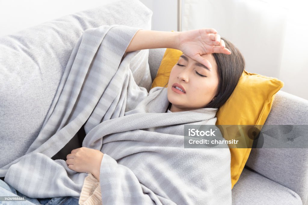 Asian Woman Touch her Forehead From Flu Headache 25-29 Years Stock Photo