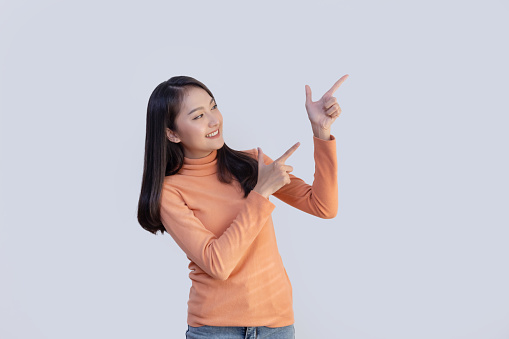 Isolated Asian Woman Pointing to Blank Space