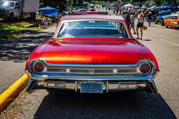 Falcon Heights, MN - June 18, 2022: High perspective rear view of a 1961 Oldsmobile Starfire Convertible at a local car show.
