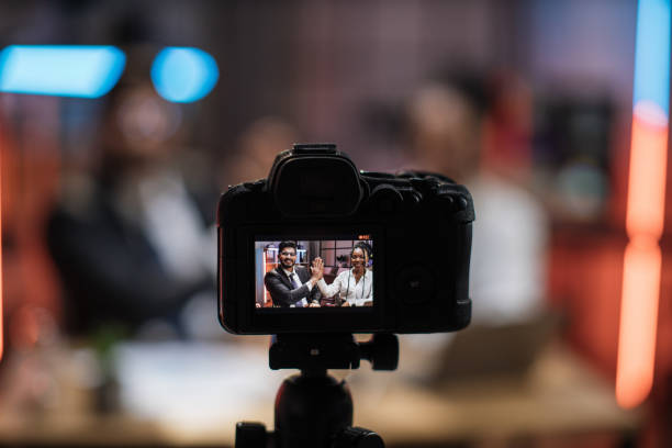 istock View from screen of camera with positive multiracial partners giving high five 1426994396