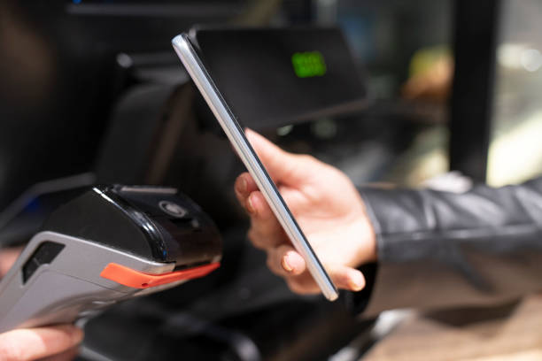 istock paying with smartphone in a cafe 1426997074