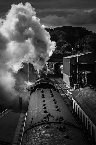 Steam train on track black and white