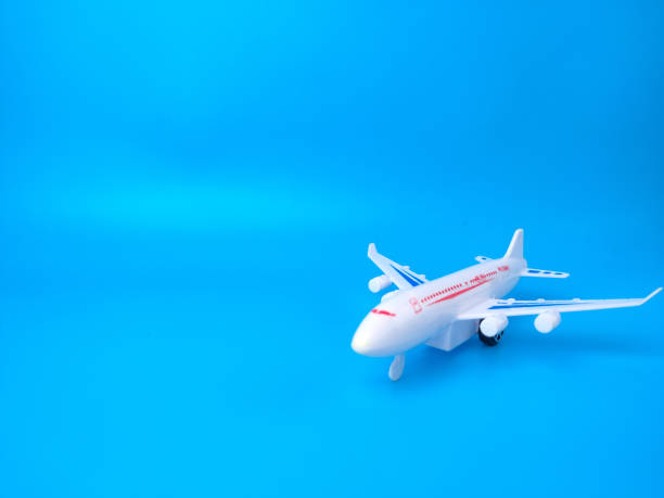istock White toy airplane on a blue background with copy space. 1426998523