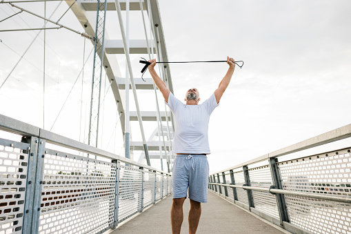 Senior man jumping rope during workout