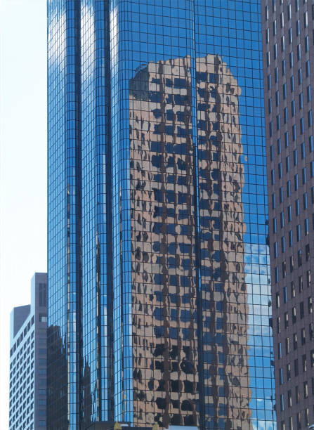istock Glass Walled Skyscraper With Reflection Of Another Building 1427008992