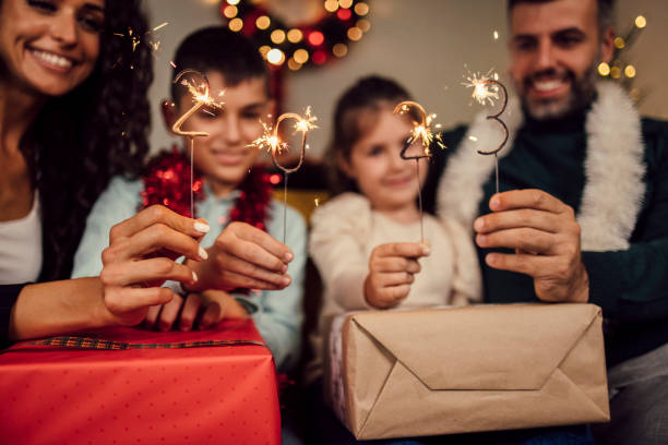 Young family celebrating New Year 2023 stock photo