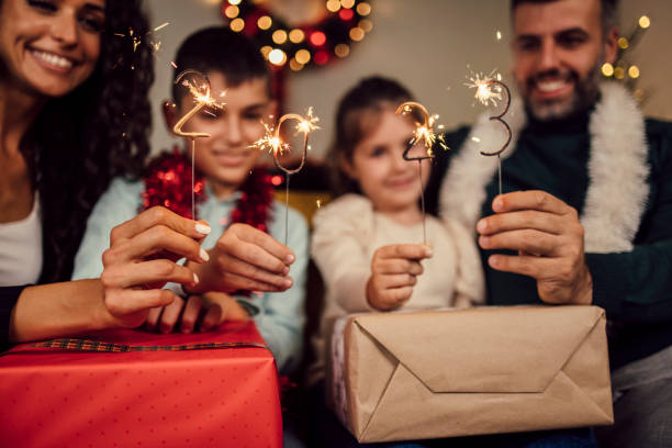 young family celebrating new year 2023 - new year people family offspring imagens e fotografias de stock