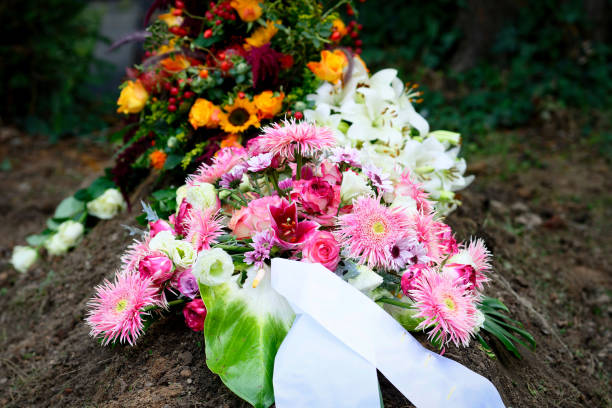 istock Funeral Flowers at grave after burial 1427016300