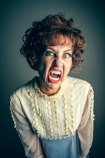 istock Gothic 60s Vintage Female Vampire Showing Her Teeth 1427020876
