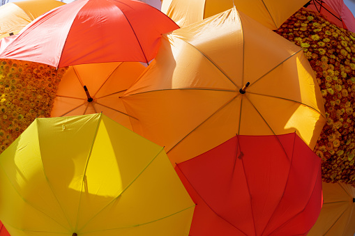 London, United Kingdom - May 22 2022: Orange and Yellow umbrellas