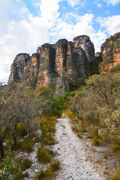 A hiking trail among rugged cliffs and Cerrado vegetation in Minas Gerais stock photo