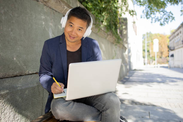 istock Young student learning online outdoors 1427040337