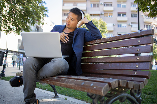 Young student learning online outdoors