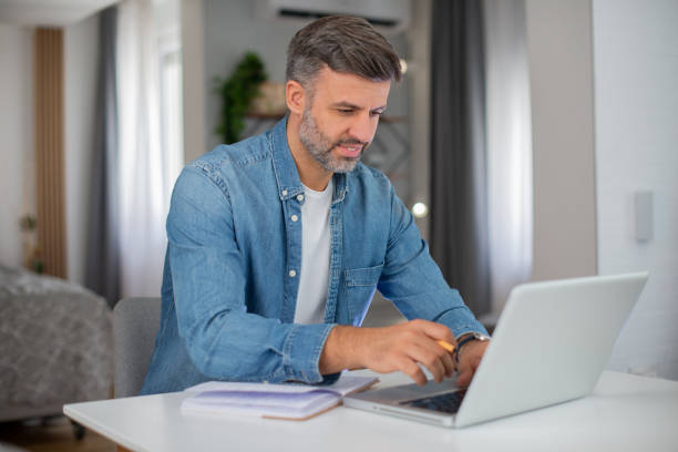 istock Mid adult man working from home 1427040991