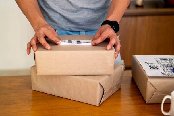 istock Man packing shoes for delivery. E-commerce. 1427052133