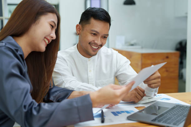 istock startup business, portrait of two entrepreneurs using computers and financial budget documents to make marketing plans to increase profits 1427060645