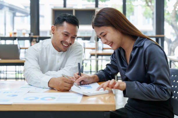 istock startup business, portrait of two entrepreneurs using computers and financial budget documents to make marketing plans to increase profits 1427060844