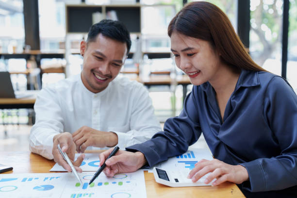 istock startup business, portrait of two entrepreneurs using computers and financial budget documents to make marketing plans to increase profits 1427061112