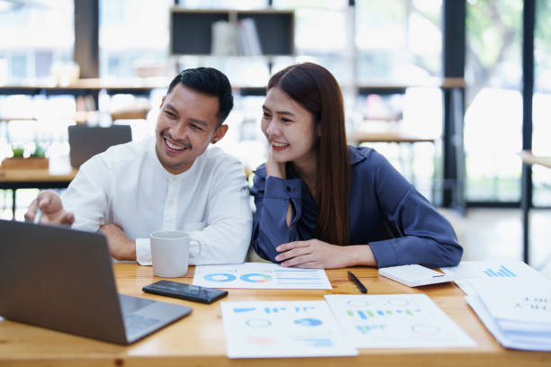istock startup business, portrait of two entrepreneurs using computers and financial budget documents to make marketing plans to increase profits 1427061138
