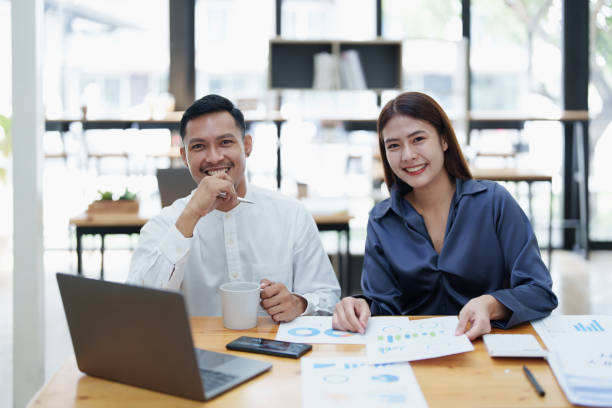 istock startup business, portrait of two entrepreneurs using computers and financial budget documents to make marketing plans to increase profits 1427061271