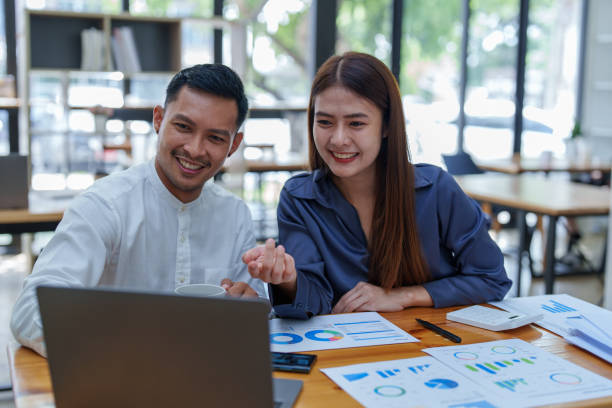 istock startup business, portrait of two entrepreneurs using computers and financial budget documents to make marketing plans to increase profits 1427061372