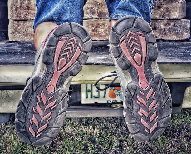 istock Shoes showing bottom sole pattern on truck car tailgate partial license plate number 1427068701