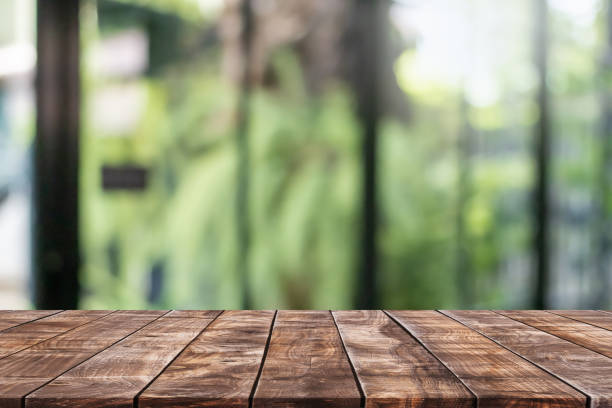 istock Empty wood table top and blurred coffee shop, cafe and restaurant interior background - can used for display or montage your products. 1427075815