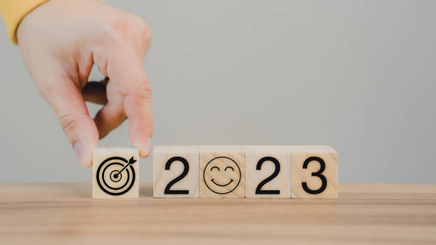 istock Hand putting wooden cube block with goal icon and 2023 icon on table background. Start new year 2023 with goal plan for work, action plan, strategy, new year business vision. 1427082821
