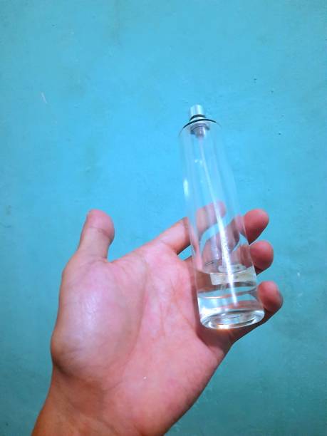 istock someone's hand is holding a perfume bottle 1427088223