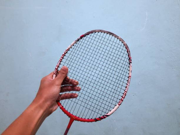 istock someone's hand is holding a badminton racket 1427088314