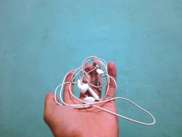 istock someone's hand is holding a headset 1427088459