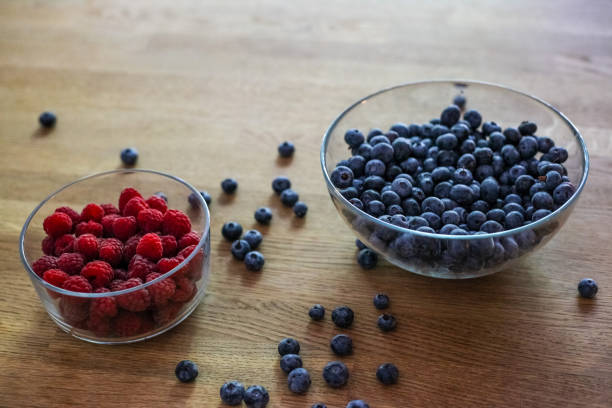 istock Bowl of blueberry and bowl of raspberry on the table 1427094921
