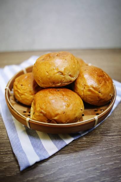 istock Mini burger buns on woven plate on purple white striped cloth 1427099522