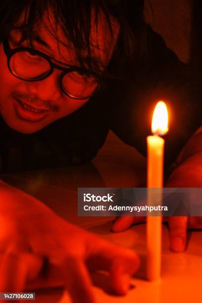 Devil Worshiper With Fire Candles Stock Photo - Download Image Now - 18-19 Years, Adult, Adults Only