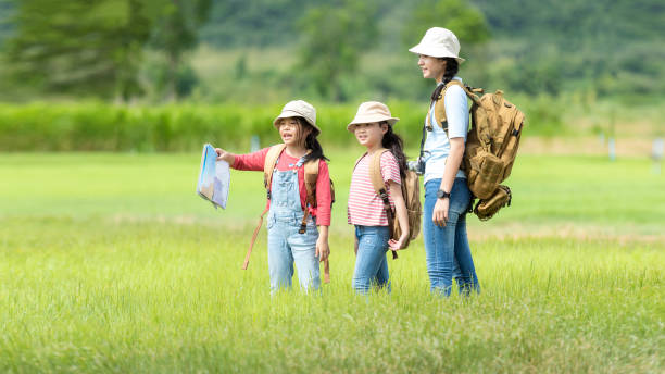 Group family children checking map in the jungle adventure.   Asia people tourism for destination leisure trips for education and relax in nature park.  Mountain background. Group family children checking map in the jungle adventure.   Asia people tourism for destination leisure trips for education and relax in nature park.  Mountain background.  Travel vacations and Life Concept funny camping signs pictures stock pictures, royalty-free photos & images