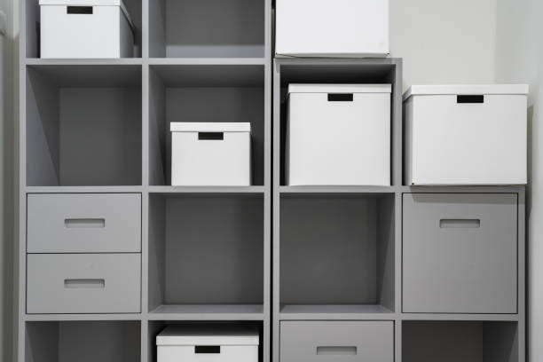 storage boxes on a grey shelf in store room. stock photo