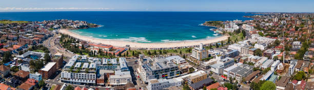 Panoramic aerial drone view of iconic Bondi Beach in Sydney, Australia with the blue ocean in the background stock photo