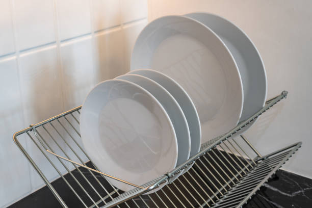 istock clean white plates in dish drying rack on kitchen counter 1427115365