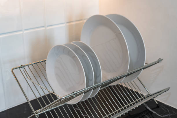 istock clean white plates in dish drying rack on kitchen counter 1427115410