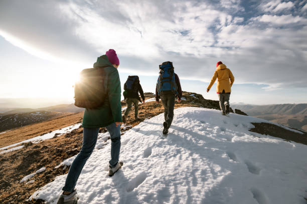 istock Group of tourists walks on mountain top 1427122710
