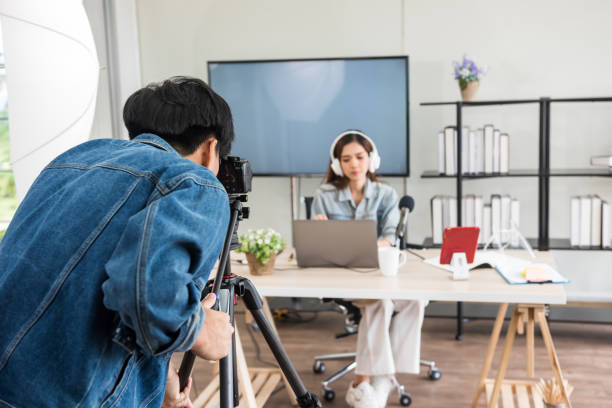 istock Behind scene. Videographer record footage for live online content 1427125011