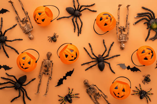 istock Halloween decorations, pumpkins, skeletons, bats, spiders on orange background 1427126967