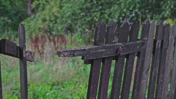 istock Old Broken Withered Wooden Fence around Private Property 1427130990